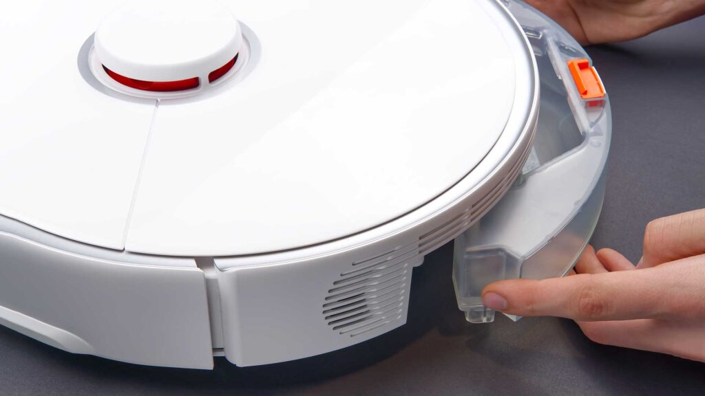 A man Quick Fix with Painter's Tape in robot vacuum.