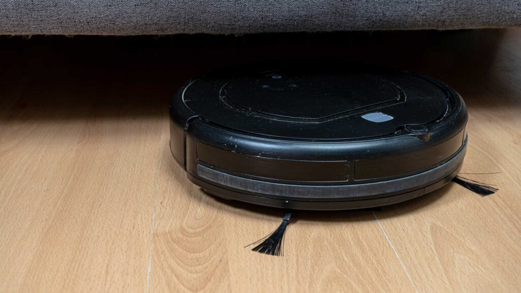 Robot vacuum cleaner cleaning under the sofa.