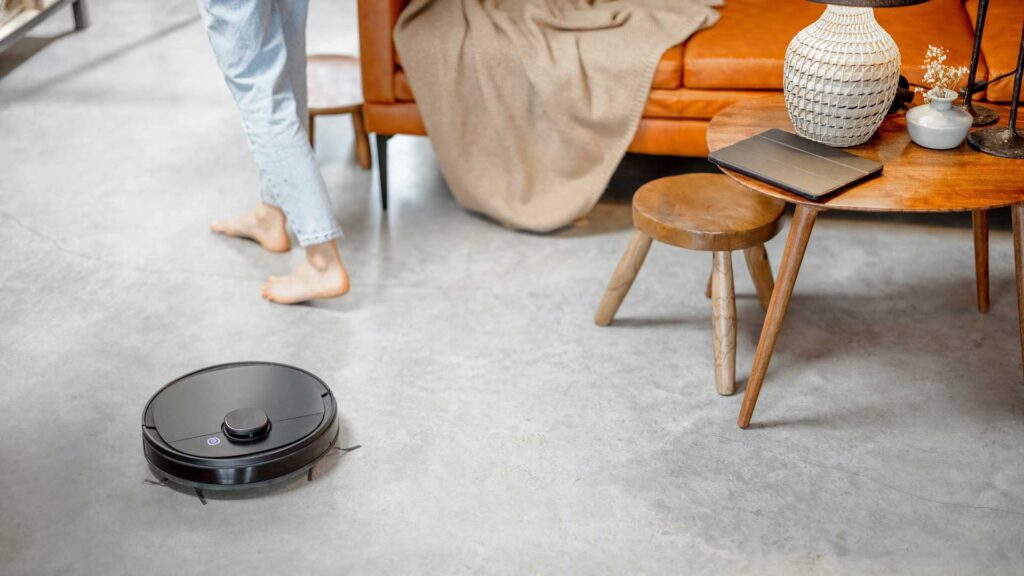 Robotic vacuum cleaner cleaning the room at home.