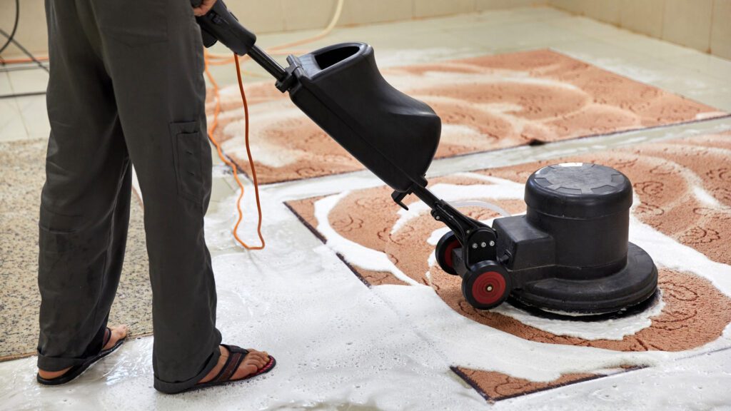 cleaning carpet with carpet cleaner