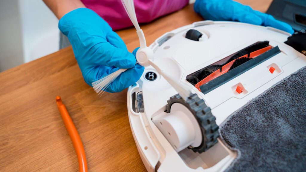 cleaning the brushes of vacuum cleaner to get dog smell out of vacuum cleaner
