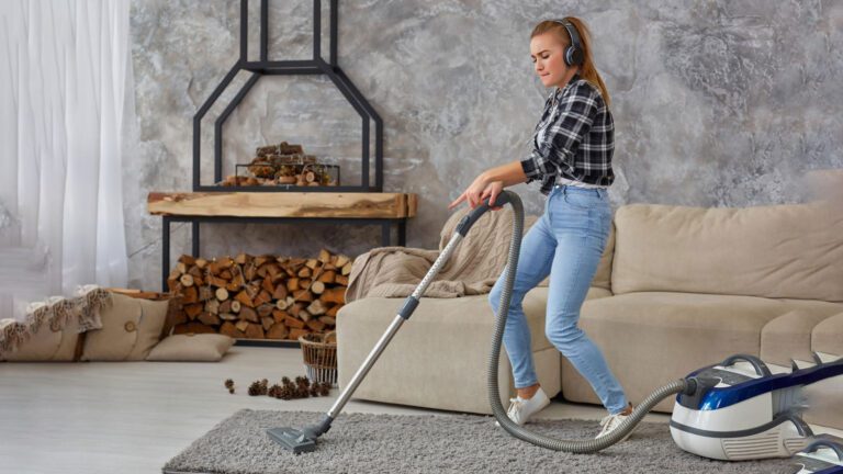 women cleaning carpet with vacuum